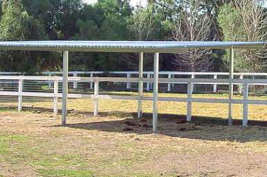 Concrete footings prepared for installing 18x18 horse shelter posts in paddock