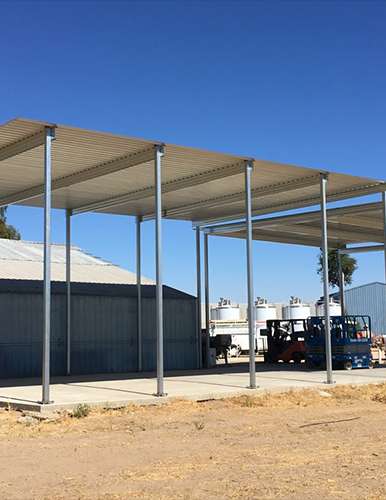 Wide view of winery crush pad cover integrated with adjacent storage facilities