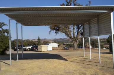 Side elevation of tall RV cover showing roof pitch and support posts