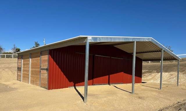 Detail of custom barn trim, doors, and roofing against clear Paso Robles sky